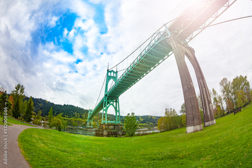 St. Johns Bridge in Portland from park below the steel suspension construction with dual gothic-style towers, built in 1931, USA St. Johns Bridge in Portland from park below the steel suspension construction with dual gothic-style towers, built in 1931, USA