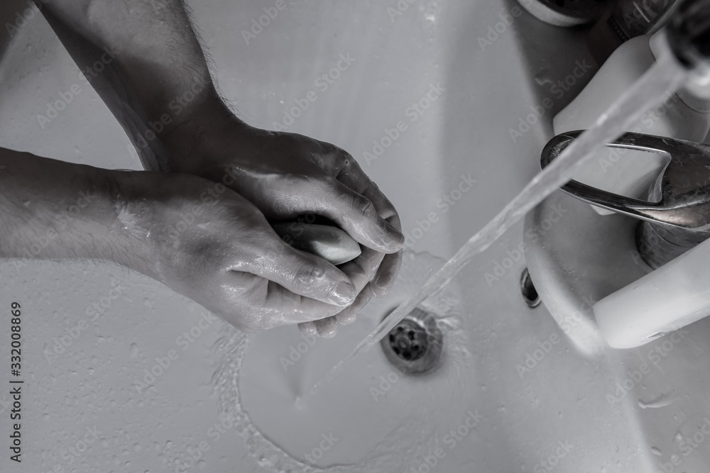 people washing hands in sink with a bar of soap to kill coronavirus