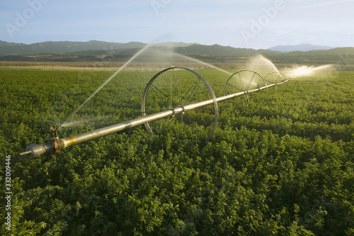 Irrigation sprinklers running in an agricultural field off of Highway 33 in Ventura County near Cuyama, California. photo