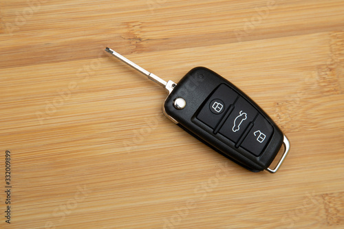 Car key on a wooden background. Production of car keys. photo