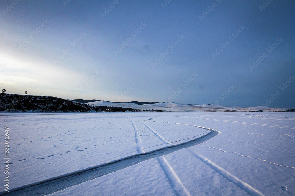 Endless ice covered by snow of Baikal Lake by winter, Russia Endless ice covered by snow of Baikal Lake by winter, Russia