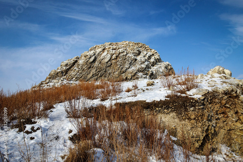 Frozen rocks of Olkhon Island view by winter, Baikal Lake, Russia
