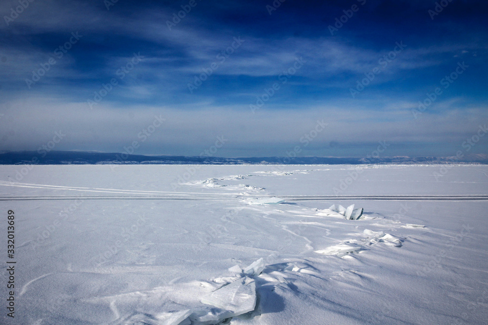 Endless ice covered by snow of Baikal Lake by winter, Russia Endless ice covered by snow of Baikal Lake by winter, Russia