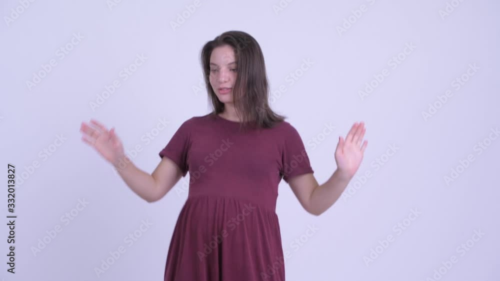 Happy young beautiful pregnant woman dancing and looking excited Happy young beautiful pregnant woman dancing and looking excited