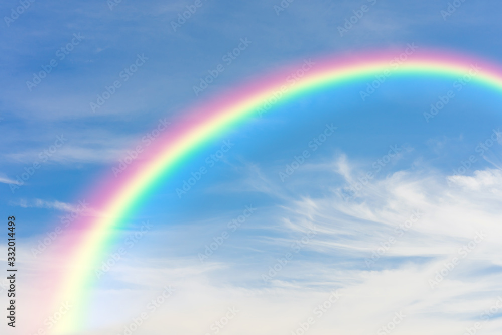 Rainbow and blue sky with clouds background