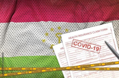 Tajikistan flag and Health insurance claim form with covid-19 stamp. Coronavirus or 2019-nCov virus concept photo