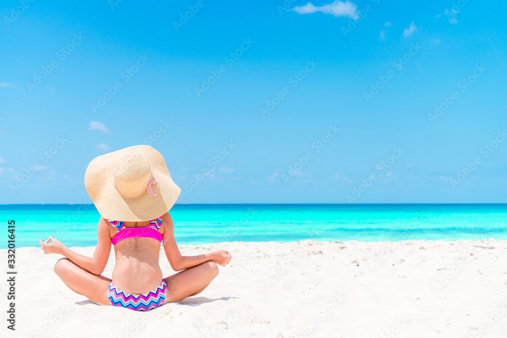 Adorable little girl have fun at tropical beach during vacation Adorable little girl have fun at tropical beach during vacation