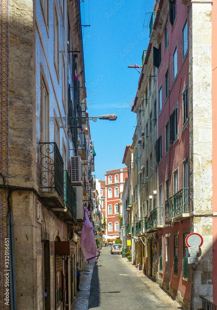 Narrow street in the historic old town of Alfama, Lisbon, Portugal