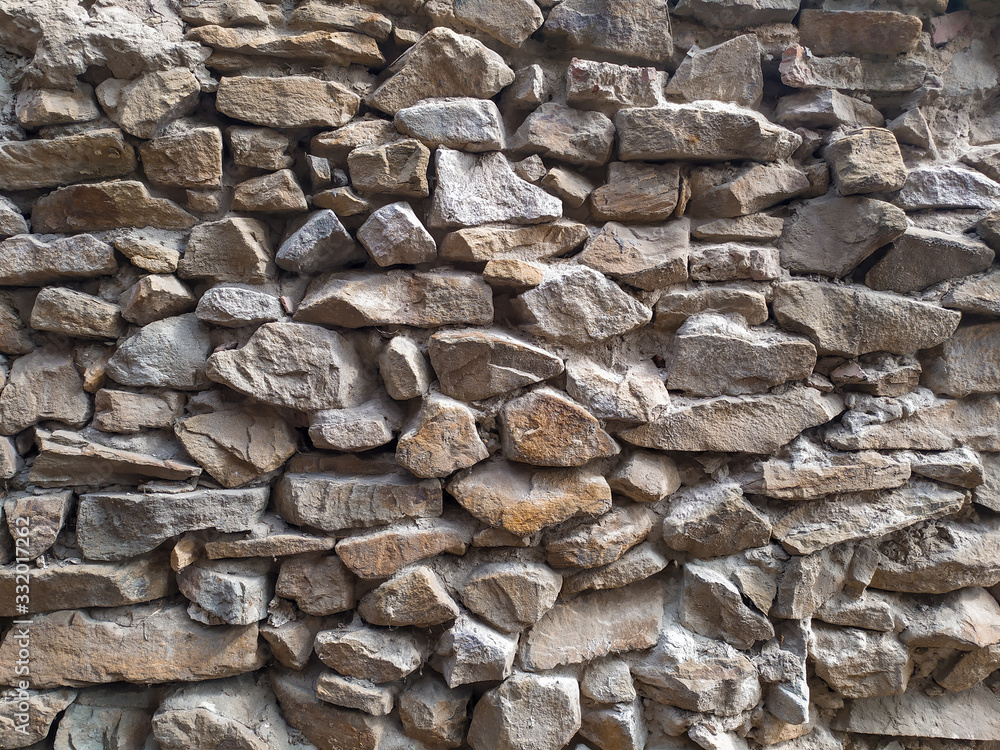 Ancient wall made of stones of different sizes. Ancient wall made of stones of different sizes.