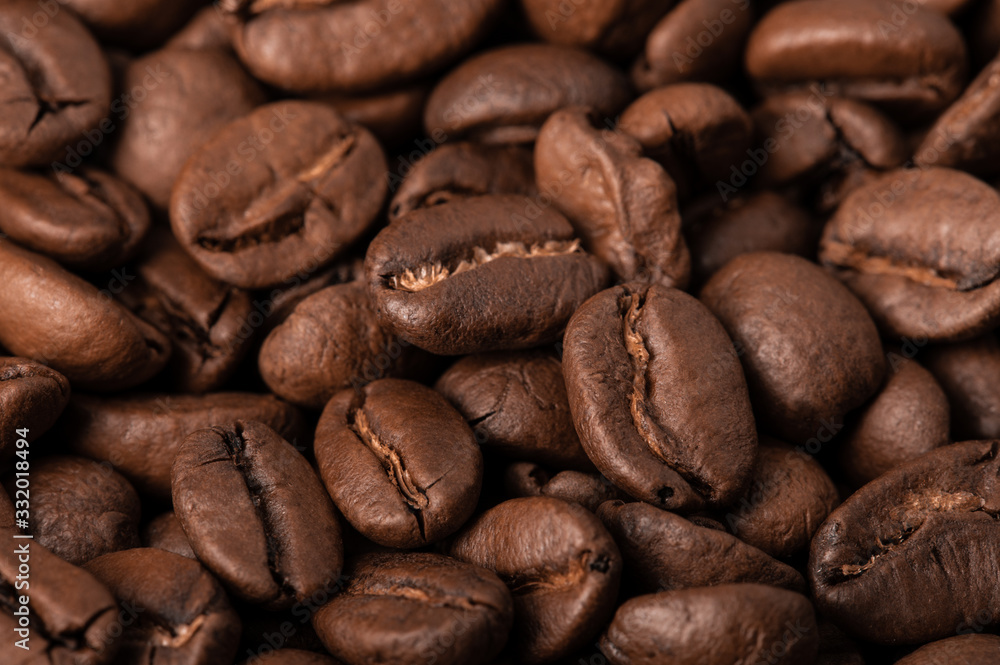 Background of coffee beans macro. Warm brown tones, the lateral scattered light. Background of coffee beans macro. Warm brown tones, the lateral scattered light.