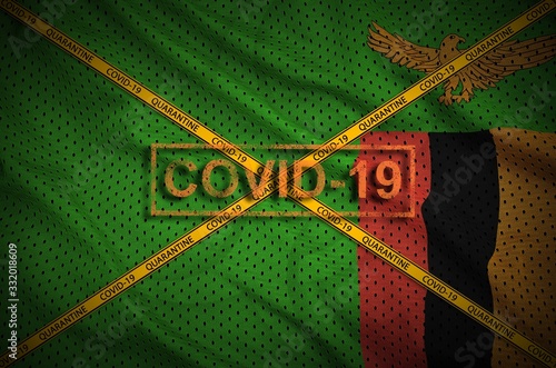 Zambia flag and Covid-19 stamp with orange quarantine border tape cross. Coronavirus or 2019-nCov virus concept photo