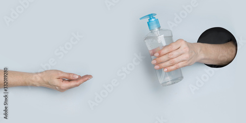 Woman washing hands with hand sanitizer to protect against Coronavirus infection. COVID-19.