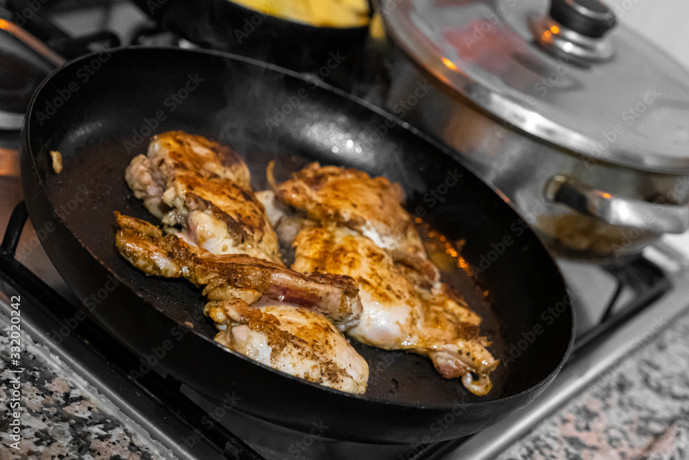 Chicken meat cooked in the pan in the home kitchen