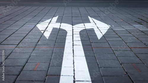 Arrow symbol on forked road. Make choice which way to go photo