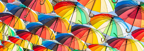 Fototapeta Naklejka Na Ścianę i Meble -  Colorful umbrellas Blue, green, red, rainbow umbrellas background Street with umbrellasin the sky Street decoration.