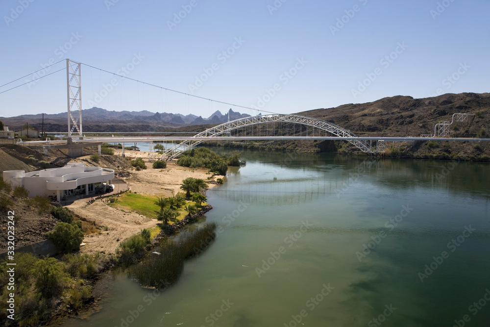 Bridge crossing Colorado River with turquoise color water from Needles California into Arizona