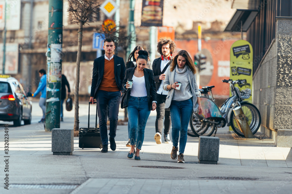 Friends Bonding, group of multi-ethnic friends walking on the streets talking to each other and smiling. Friends Bonding, group of multi-ethnic friends walking on the streets talking to each other and smiling.