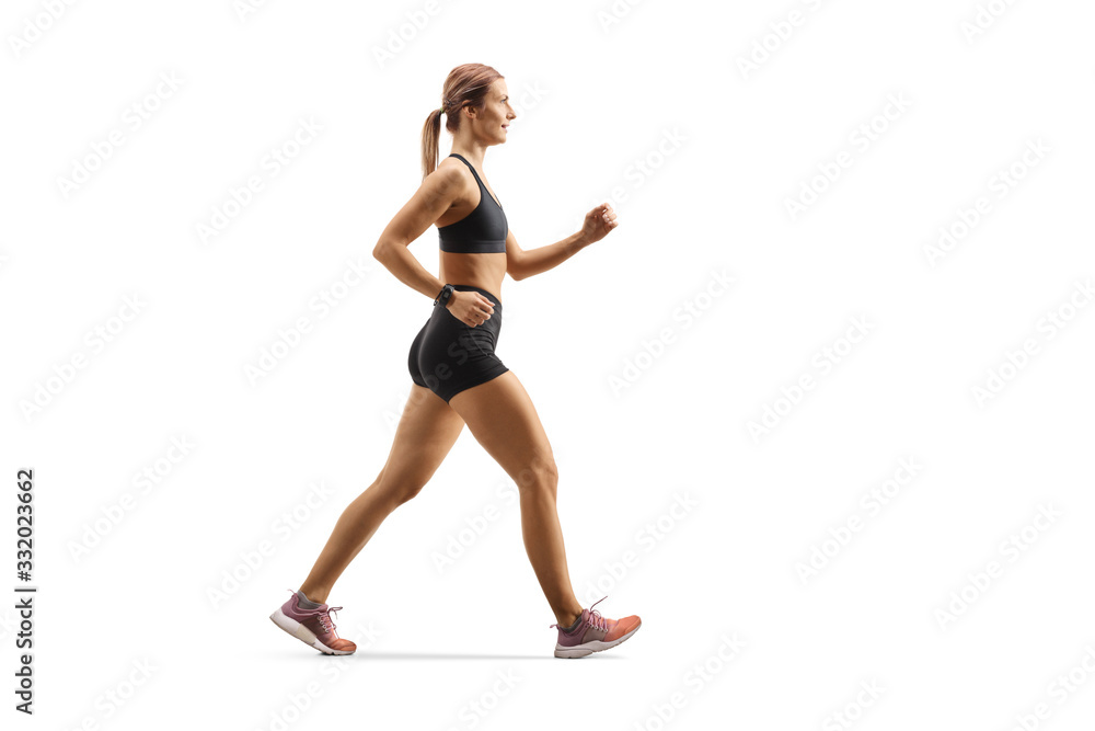 Strong young woman in sportswear running