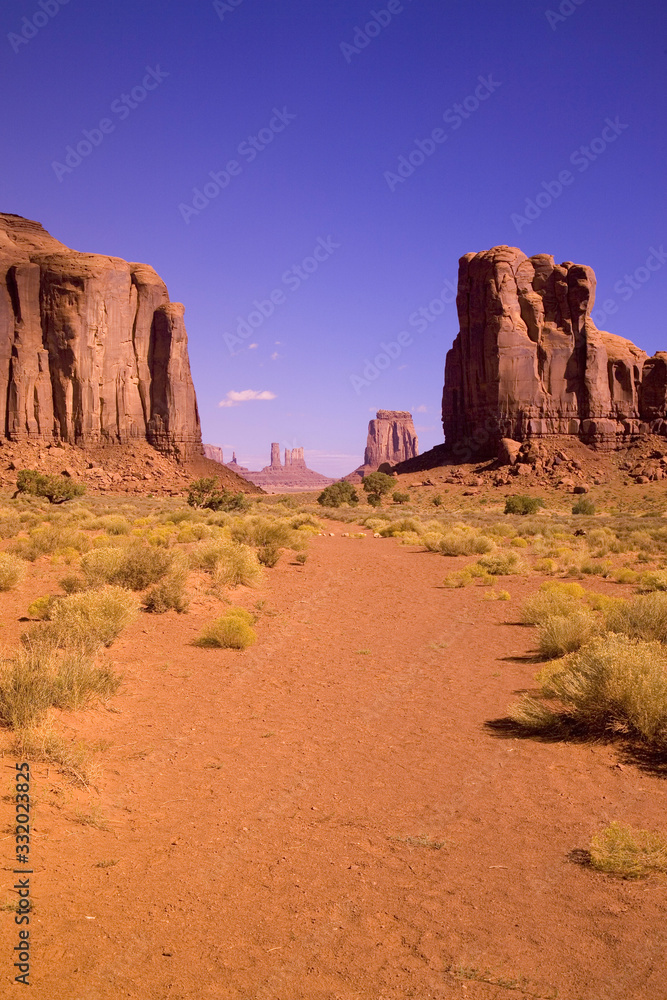 Fototapeta premium Red buttes and colorful spires of Monument Valley Navajo Tribal Park, Southern Utah near Arizona border