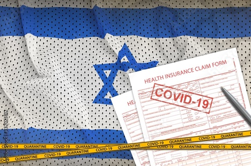 Israel flag and Health insurance claim form with covid-19 stamp. Coronavirus or 2019-nCov virus concept photo