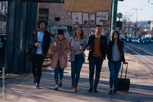 Group of friends (colleagues) hanging out in an urban area.