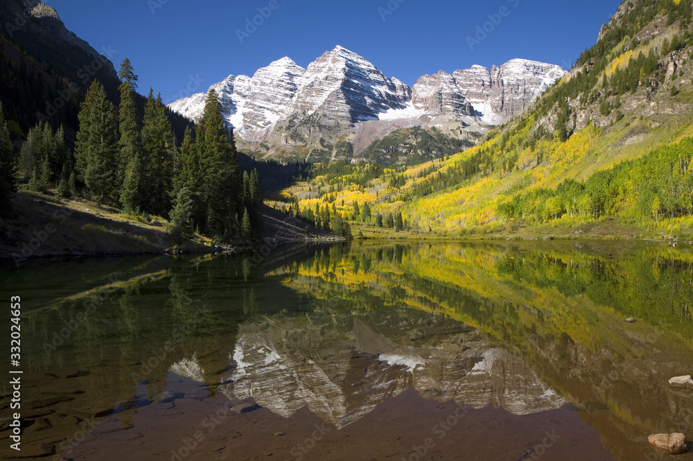 Autumn colors of Aspens reflecting in lake under Maroon Bells, Colorado, near Aspen