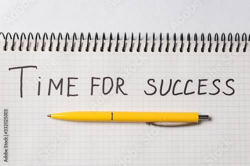 Motivational inscription TIME TO SUCCESS. Notebook and pen. Close up