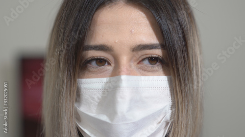  A woman put on mask to protect from virus as coronavirus  covid-19. Close up shot.