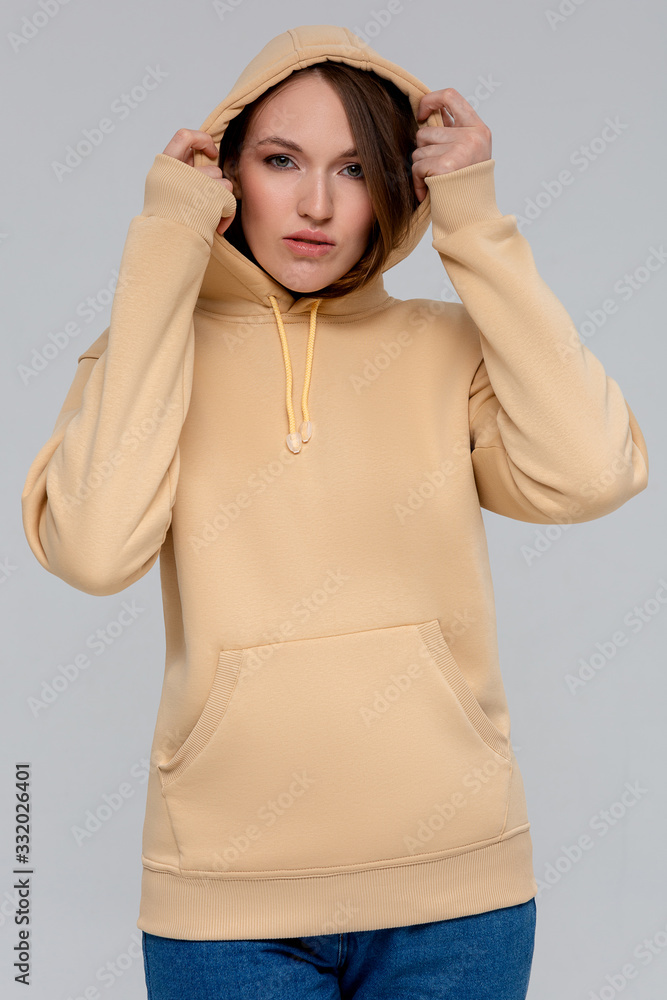 Woman in gold hoodie, mockup for logo or branding design Woman in gold hoodie, mockup for logo or branding design