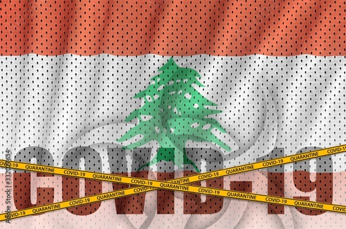 Lebanon flag and Covid-19 inscription with orange quarantine border tape. Coronavirus or 2019-nCov virus concept photo