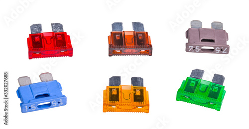 Set of automotive blade type fuses with two metal prongs isolated on white. Group of colored plastic overcurrent protectors with rated current in amperes. Electric safety device used in automobiles. photo