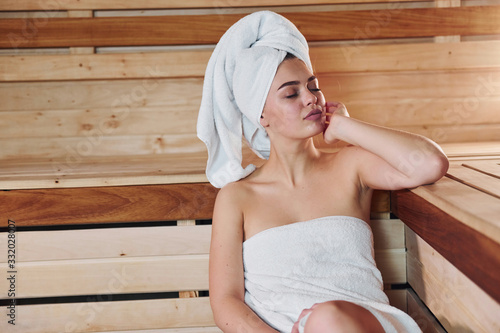 Young beautiful woman have a rest in the sauna. Conception of bodycare