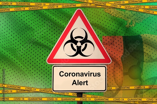 Zambia flag and Covid-19 biohazard symbol with quarantine orange tape. Coronavirus or 2019-nCov virus concept photo