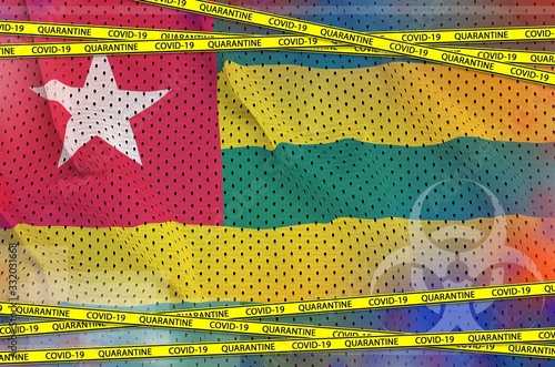 Togo flag and Covid-19 quarantine yellow tape. Coronavirus or 2019-nCov virus concept photo