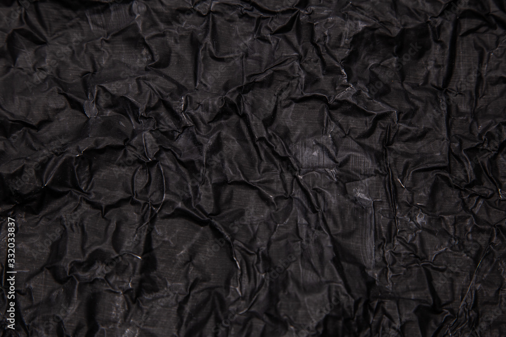 Black background. A crumpled texture. Close-up. Black background. A crumpled texture. Close-up.