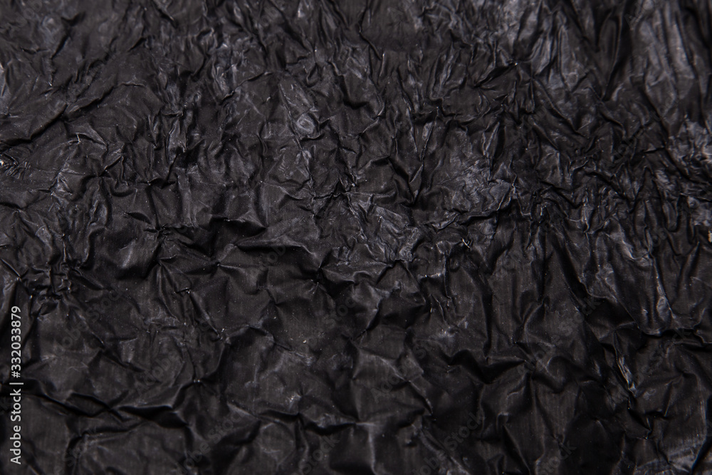 Fototapeta premium Black background. A crumpled texture. Close-up.