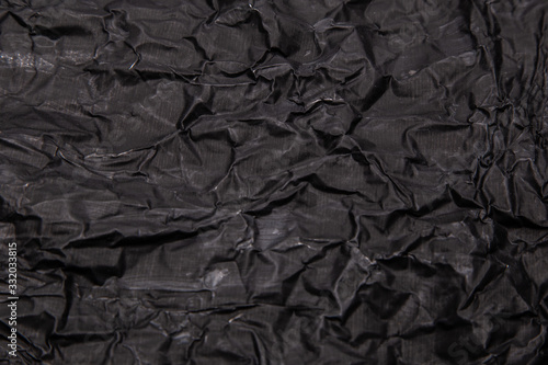 Black background. A crumpled texture. Close-up.
