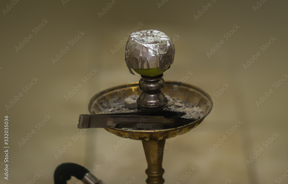 Bowl and head of Syrian hookah made of green apple, with foil on it. After use. Bowl and head of Syrian hookah made of green apple, with foil on it. After use.
