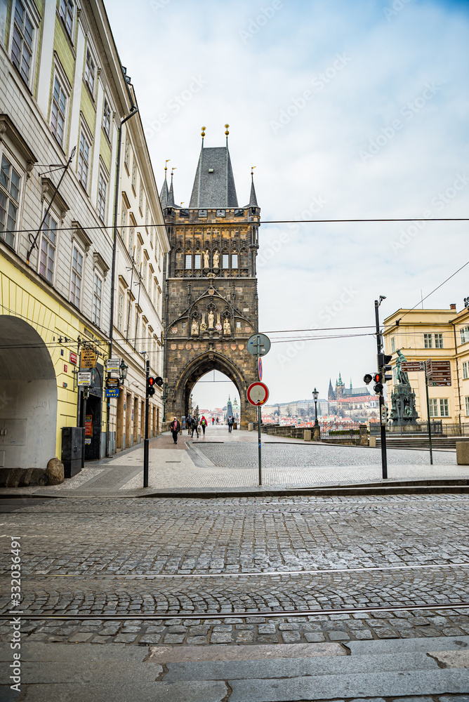 Fototapeta premium Prague, Czech republic - March 19, 2020. Square Krizovnicke namesti in front of entrance to Charles Bridge without tourists during Covid-19 travel ban