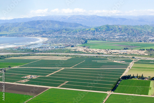 Aerial view of Oxnard farm fields in spring with Ventura City and Pacific Ocean in background, Ventura County, CA