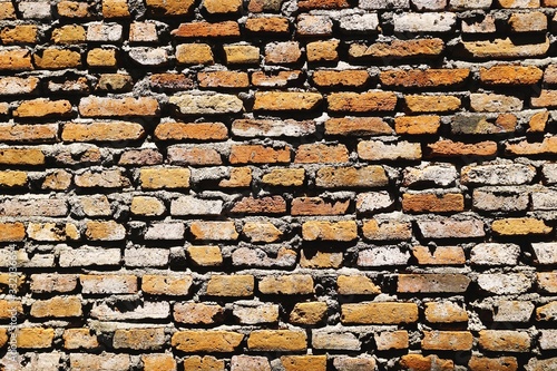 Canvas Print Sloppy brick wall with uneven bricks and rough mortar horizontal background text
