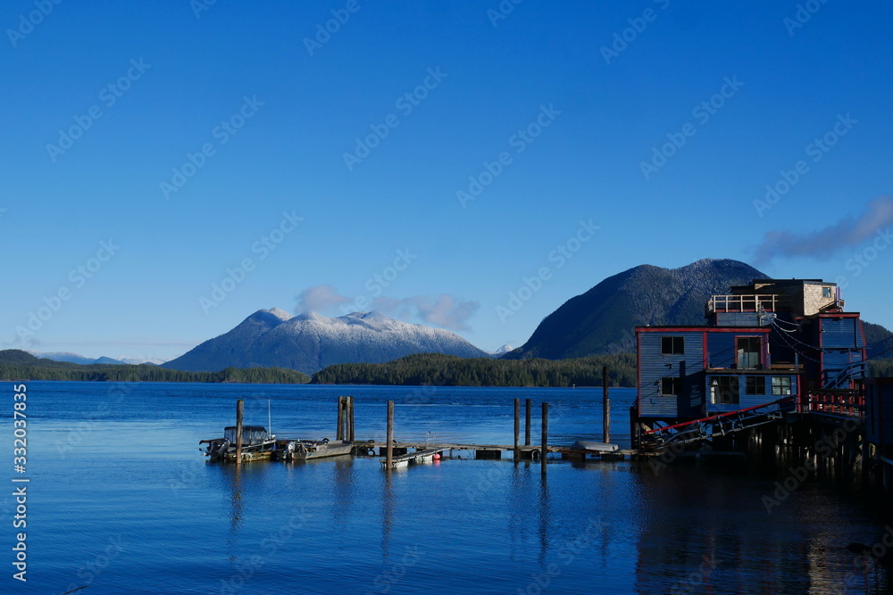 View of mountains across water from quiet harbor