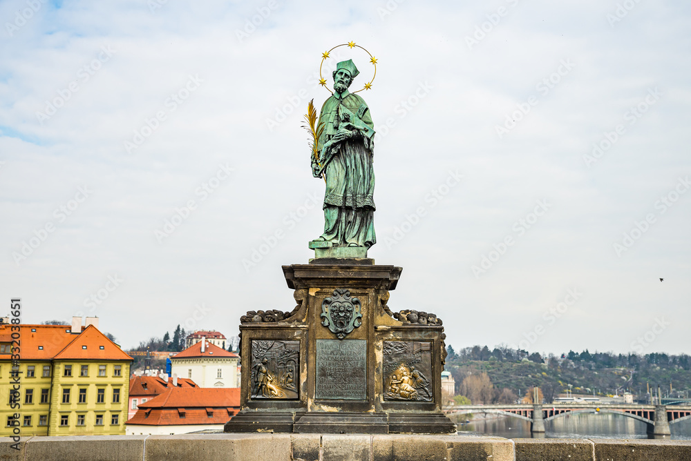 Fototapeta premium Prague, Czech republic - March 19, 2020. Statues of Charles Bridge without tourist during Covid-19 travel ban