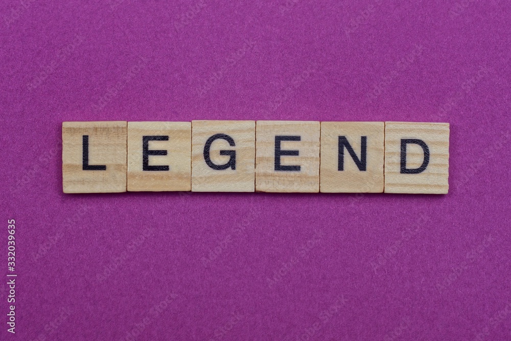 word legend made from wooden letters lies on a red table word legend made from wooden letters lies on a red table