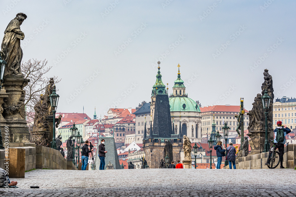 Obraz premium Prague, Czech republic - March 19, 2020. Statues of Charles Bridge without tourist during Covid-19 travel ban