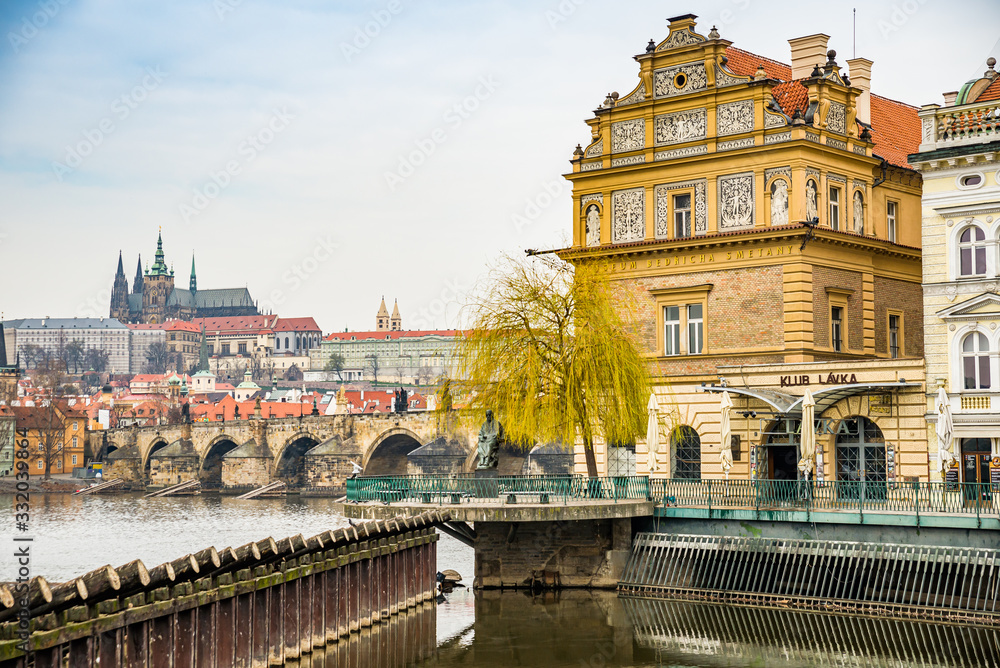 Prague, Czech republic - March 19, 2020. Novotneho lavka area with Bedrich Smetana statue by the Vltava river without tourists during travel ban