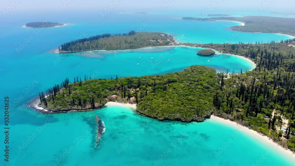 Surrounded by plants of coconut trees and column pines, the beach of Kanumera bay is ideal for snorkeling in the scenario of the Isle of Pines in New Caledonia. Surrounded by plants of coconut trees and column pines, the beach of Kanumera bay is ideal for snorkeling in the scenario of the Isle of Pines in New Caledonia.