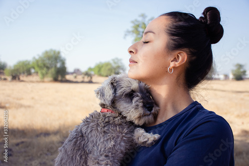 Young woman and her adorable schnauzer dog 