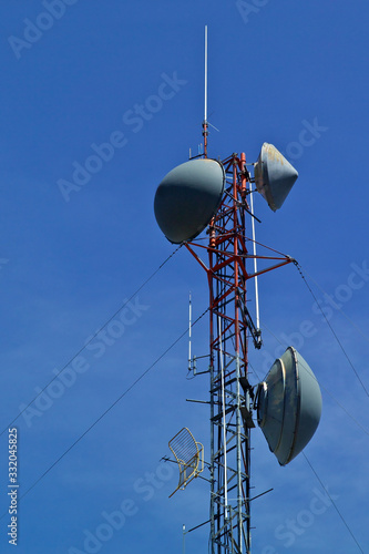 Microwave relay tower with whip antenna  photo