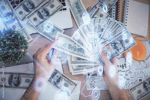 Multi exposure of technology drawing hologram and us dollars bills and man hands. Data concept